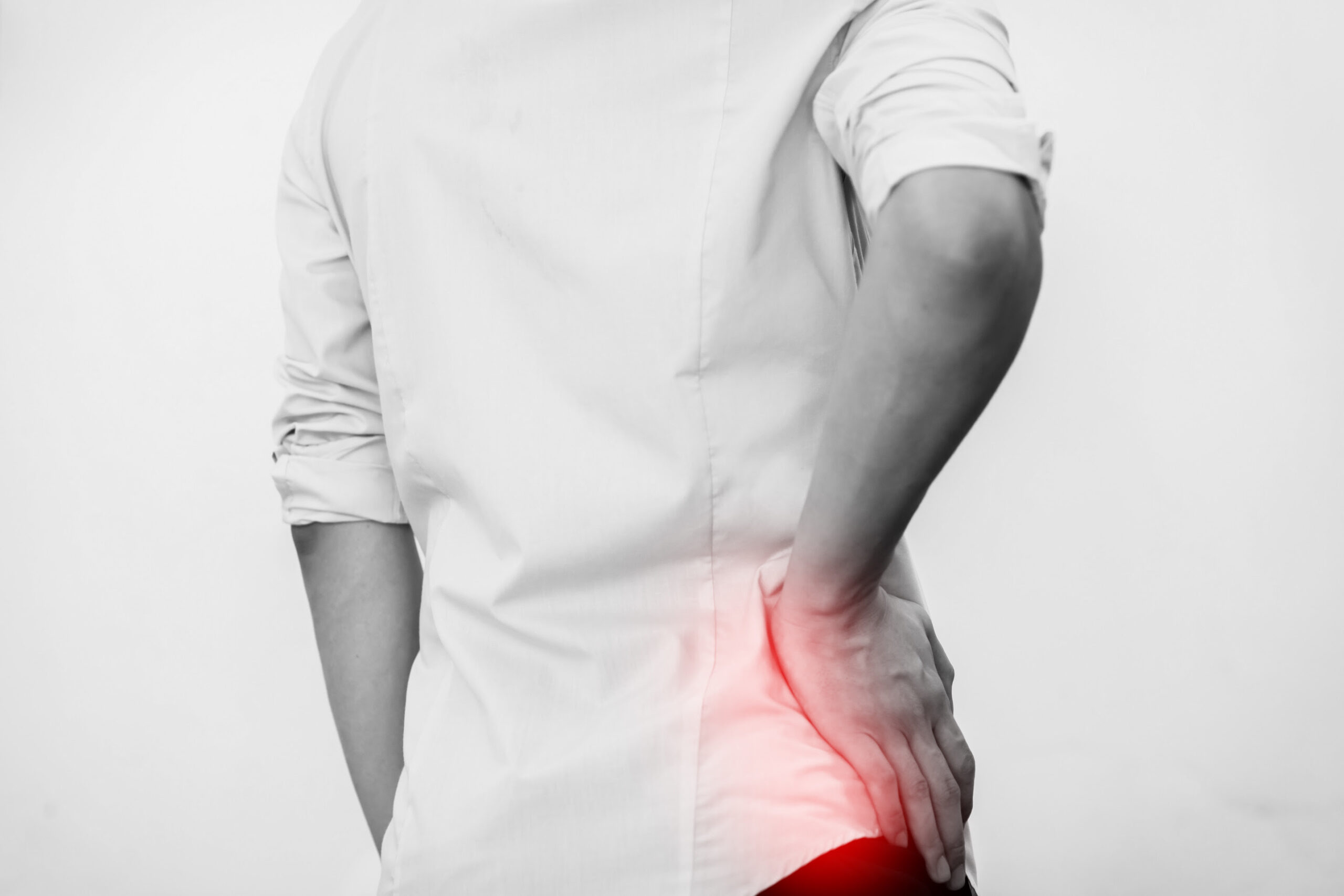 Young man in casual office shirt having hip pain